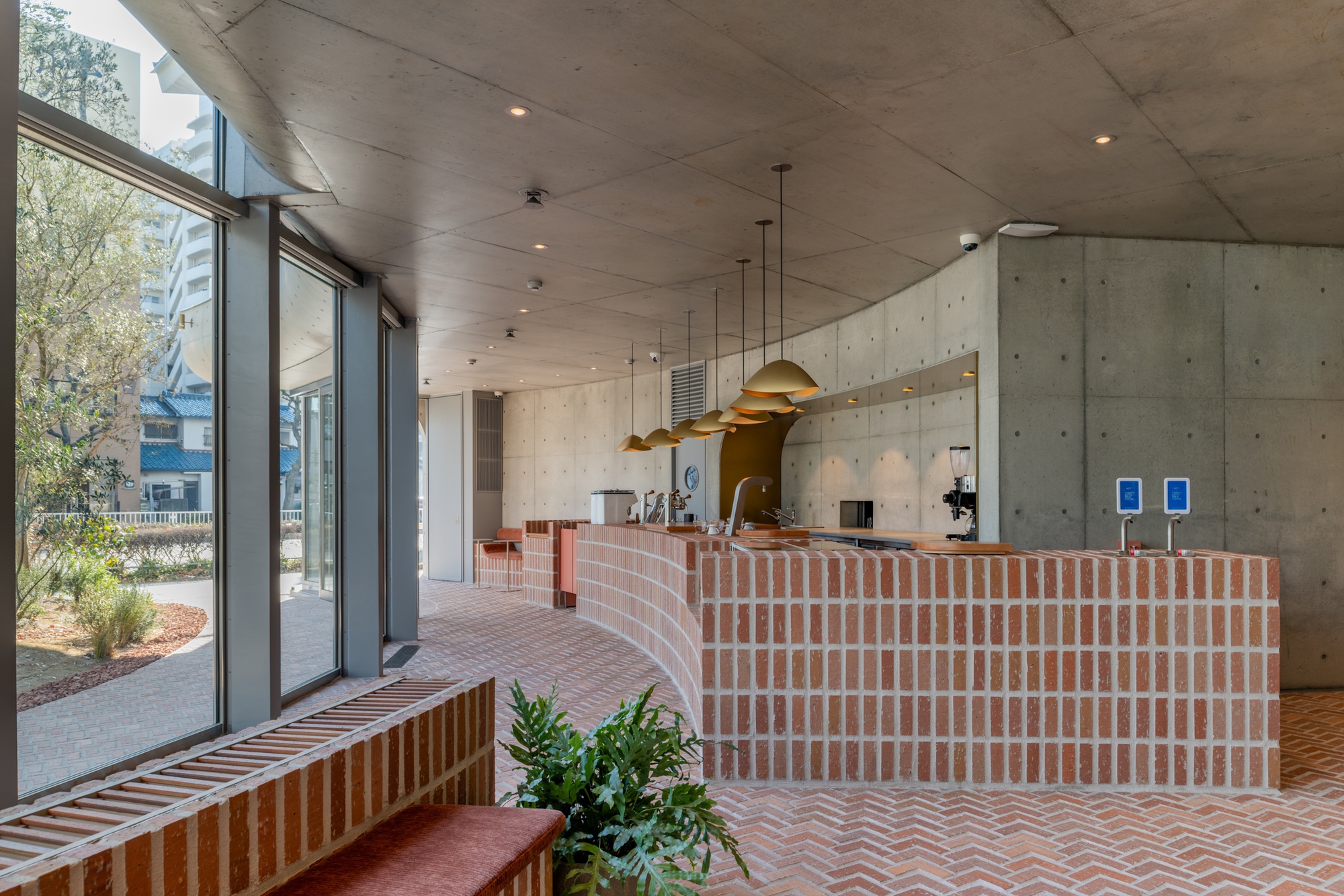 Curved brick counter on the ground floor of AOI Celestie Coffee Roastery