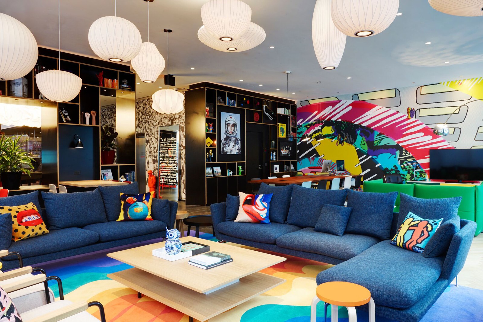 Blue sofas and mural in the living room of citizenM Washington DC Capitol