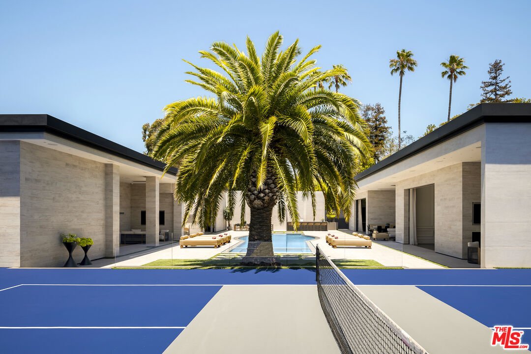 테니스 코트 너머로 보이는 수영장과 저택 양쪽 동