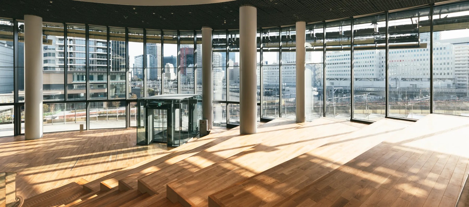 Timber floored hall with city view at MoN Takanawa