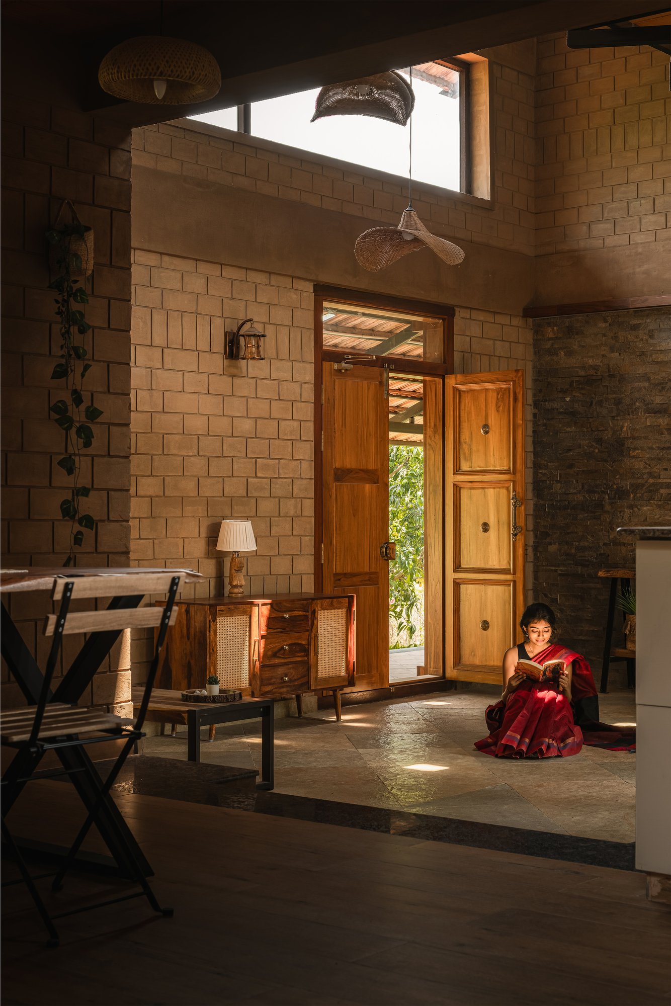 Saffron Verandah House earthen wall approach with deep roof overhang