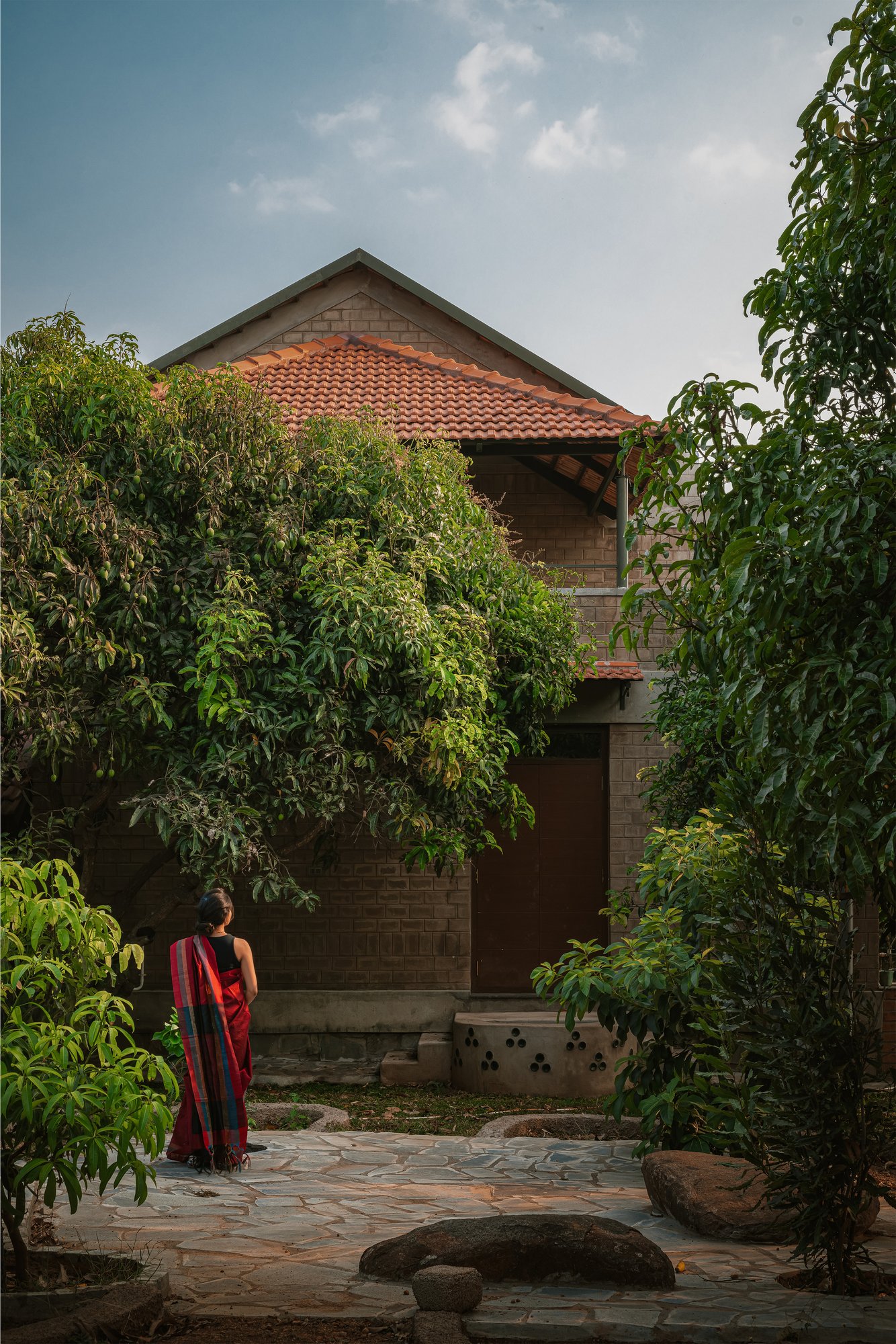 Saffron Verandah House exterior nestled among mango trees