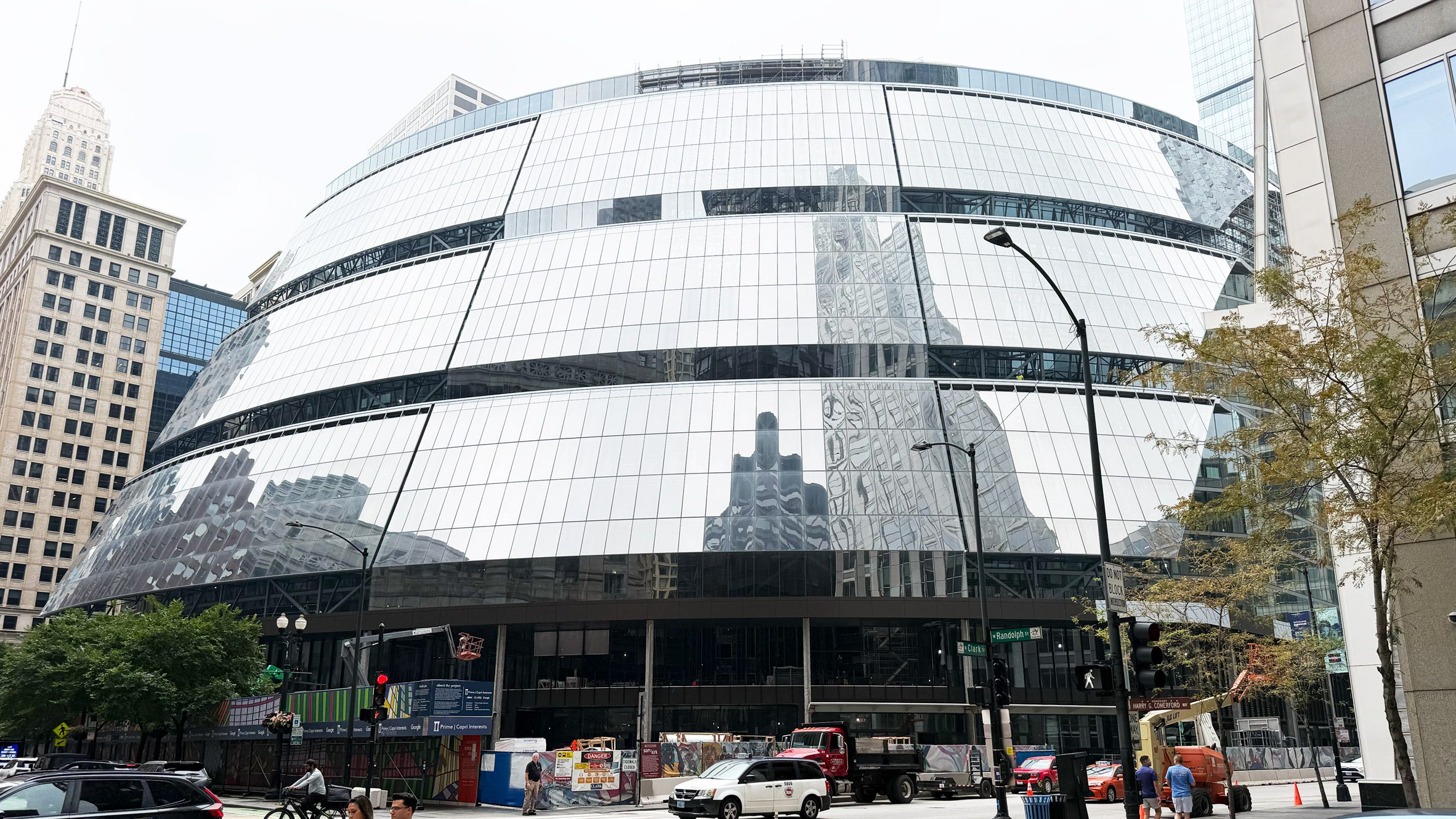 타원형 곡면 유리 파사드로 새로 단장한 Thompson Center 외관과 시카고 시내 거리 풍경