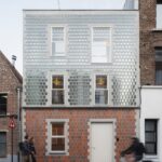 자전거와 행인이 지나는 거리에서 본 Glass Brick House