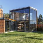 잔디 마당 쪽에서 본 Casa Ortega 유리 박스 볼륨